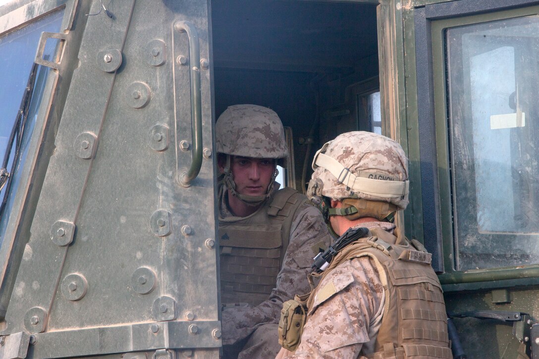 Capt. Michael Gagnon, right, and Cpl. Christopher Cane discuss the construction of a helicopter landing zone for a special operations outpost in the Helmand River valley of southwestern Afghanistan, Oct. 21. Gagnon, a native of Oxford, Mass., commands a team of roughly 20 men dubbed “Task Force Nomad.” Cane, from Olympia, Wash., serves as a heavy equipment operator with the task force. Over the next several weeks, the task force, a subset of Marine Wing Support Squadron 371, will construct or improve helicopter landing zones along the Helmand River valley in southwestern Afghanistan.
