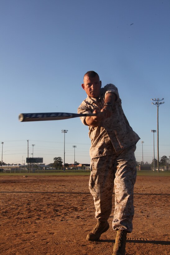 Master Gunnery Sgt. Kevin D. Basso demonstrates a good swing at the Softball Complex Oct. 21. “On the field I work hard and expect my players to do the same thing,” said Basso. “I expect my Marines in the office to turn in their work at near perfection.”