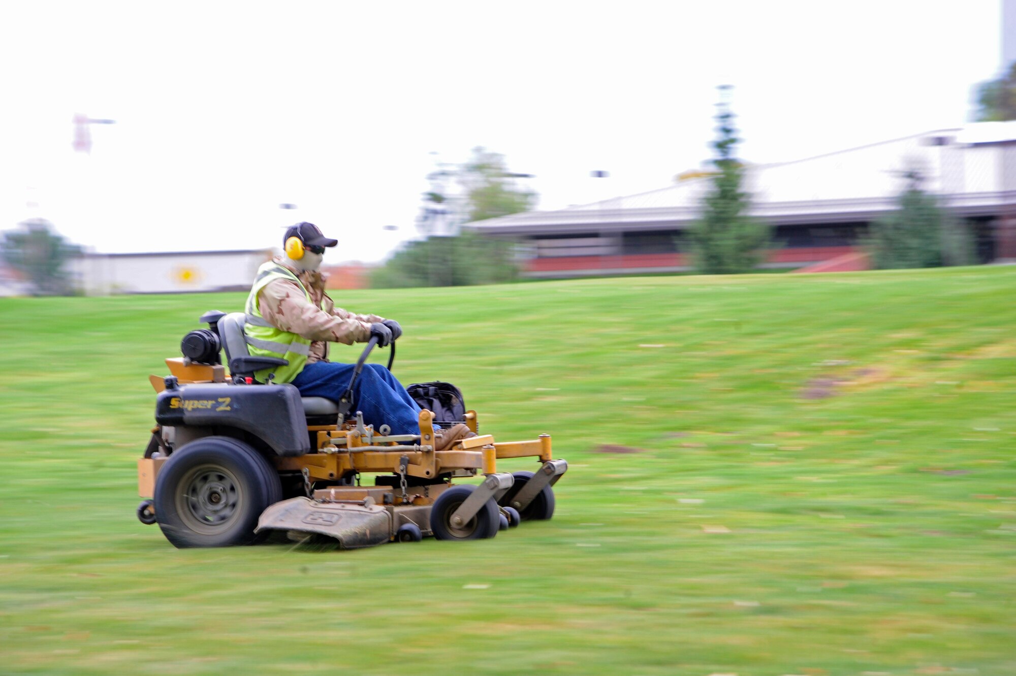 Brandon Laudensluger, from the grounds maintenance section, cuts the grass outside the commissary on a riding lawn mower Oct. 14. Brandon has been with Skils’kin for six months. The word Skils’kin is a Native American word meaning a place where people come to learn about themselves. (U.S. Air Force photo/Airman 1st Class Taylor Curry)