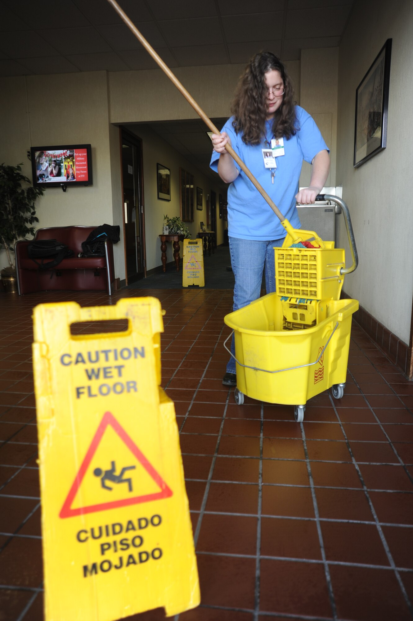 Deborah Melideo, Skils’kin janitorial custodian, mops floors at the Deel Community Center Oct. 13. She has been an employee with Skils’kin for six years. The mission of Skils’kin is to provide support and services to people with disabilities. (U.S. Air Force photo/Airman 1st Class Earlandez Young)