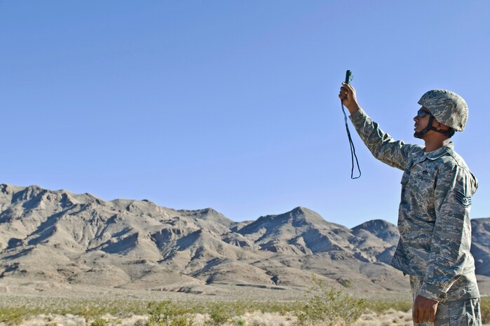 U.S. Air Force Staff Sgt. Odell Glasper, 820th RED HORSE heavy equipment and pavement craftsman, checks the wind speed in preparation for an airdrop training mission Oct. 15, 2011, at Nellis Air Force Base, Nev. RED HORSE Airmen perform airdrop missions to stay current on training and certifications, which enables them to perform jump missions and operate their own drop zones. (U.S. Air Force photo by Airman 1st Class Matthew Lancaster/Released)