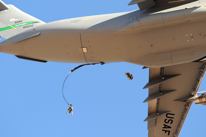 U.S. Air Force Airmen, 820th RED HORSE airborne flight, parachute into a drop zone from a C-17 Globemaster III Oct. 15, 2011, at Nellis Air Force Base, Nev.  RED HORSE and 6th Combat Training Squadron Airmen perform airdrop missions to stay current on training and certifications, which enables them to perform jump missions and operate their own drop zones. (U.S. Air Force photo by Staff Sgt. Taylor Worley/Released)
