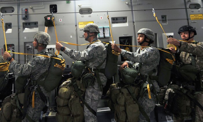 U.S Air Force Airmen, 820th RED HORSE airborne flight, 6th and 414th Combat Training Squadrons, go over final checks on board a C-17 Globemaster III before a jump mission Oct. 15, 2011, at Nellis Air Force Base, Nev.  RED HORSE, 6th and 414th CTS Airmen perform airdrop missions to stay current on training and certifications, enabling them to perform jump missions and operate their own drop zones. (U.S. Air Force photo by Senior Master  Sgt.  Kevin Gruenwald/Released)
