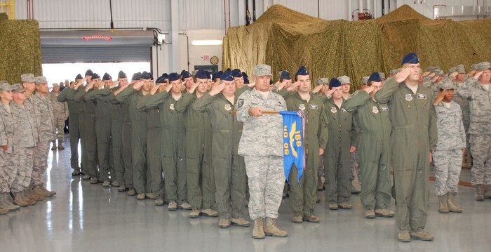 166th Operations Group director of operations Lt. Col. Rob Culcasi, and First Sergeant Master Sgt. Sean O’Neill, holding unit guidon, with over 210 Airmen from the 166th OG, 166th Maintenance Group and 166th Mission Support Group of the Del. ANG, their families and invited guests at a welcome home ceremony Oct. 16, 2011 in the main maintenance hangar at the New Castle ANG Base, Del. The Airmen completed missions lasting three to six months in various locations in Southwest Asia (primarily in Afghanistan), Europe and the U.S., chiefly in support of Operation Enduring Freedom. (U.S. Air Force photo/Tech. Sgt. Benjamin Matwey)