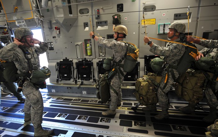U.S Air Force Tech. Sgt. Mitchell Romag, 820th RED HORSE airborne jumpmaster, shouts out commands on board a C-17 Globemaster III before a jump mission Oct. 15, 2011, at Nellis Air Force Base, Nev.  Airmen from the 820th RED HORSE, 6th and 414th Combat Training Squadrons perform airdrop missions to stay current on training and certifications, which enables them to perform jump missions and operate their own drop zones. (U.S. Air Force photo by Senior Master Sgt. Kevin Gruenwald/Released)


