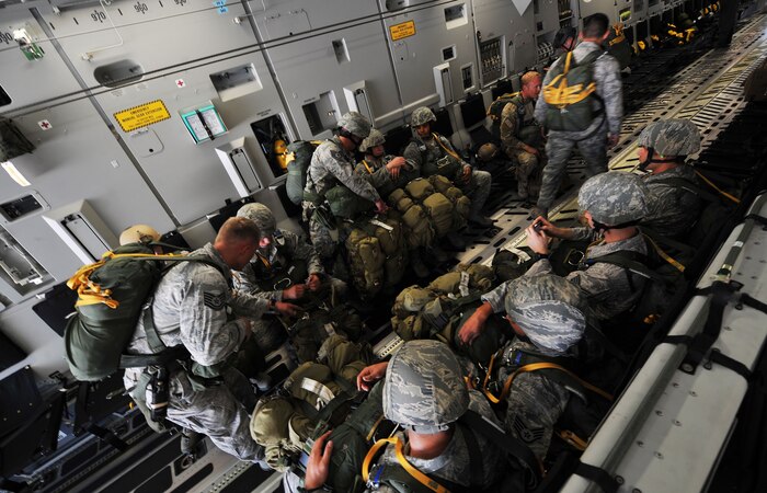 U.S Air Force Airmen, 820th RED HORSE airborne flight, 6th and 414th Combat Training Squadron, go over final checks on board a C-17 Globemaster III before a jump mission Oct. 15, 2011, at Nellis Air Force Base, Nev.  RED HORSE, 6th and 414th CTS Airmen perform airdrop missions to stay current on training and certifications, enabling them to perform jump missions and operate their own drop zones. (U.S. Air Force photo by Senior Master  Sgt.  Kevin Gruenwald/Released)