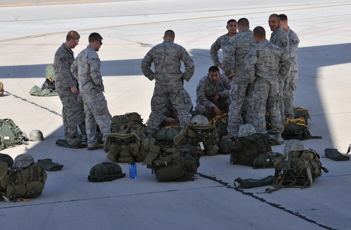 U.S Air Force Airmen, 820th RED HORSE airborne flight, go over final preparations before a jump mission Oct. 15, 2011, at Nellis Air Force Base, Nev.  RED HORSE  Airmen perform airdrop missions to stay current on training and certifications, enabling them to perform jump missions and operate their own drop zones. (U.S. Air Force photo by Senior Master  Sgt.  Kevin Gruenwald/Released)