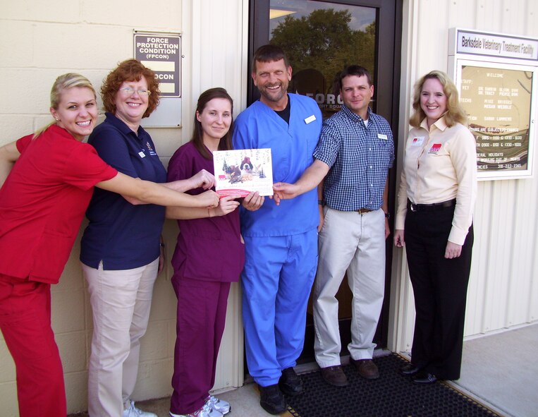 Members from the Barksdale Veterinary Clinic and (far right) Lisa Lopshire, American Animal Hospital Association veterinary practice manager, pose with their AAHA accreditation certificate in front on the clinic on Barksdale Air Force Base, La., Sept. 29. Lopshire performed an audit on the clinic to make sure they were compliant with AAHA standards. The Barksdale vet clinic is one of only three local accredited clinics. (Courtesy photo) (RELEASED)
