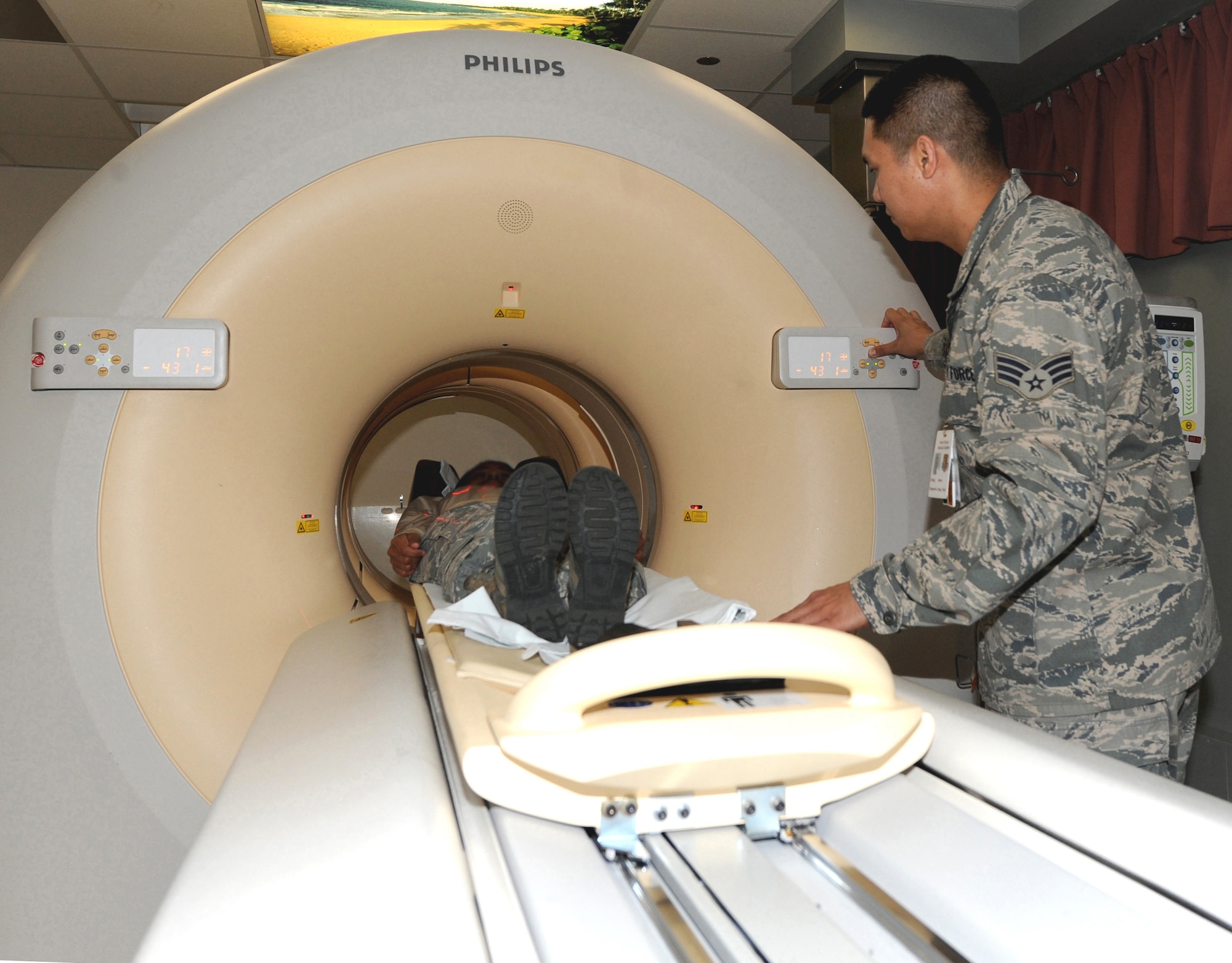 Senior Airman Mario Lintag, computerized tomography technologist, performs a CT scan of a patient Oct. 14 at the David Grant USAF Medical Center. Radiologists use specialized equipment and expertise to create and interpret CT scans of the body, so they can more easily diagnose medical problems. (U.S. Air Force photo/ Staff Sgt. Liliana Moreno)