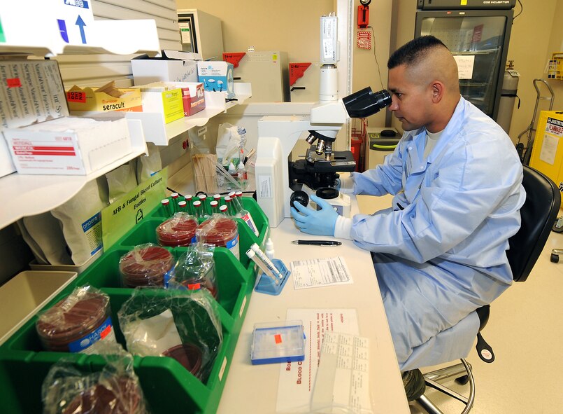 Airman 1st Class Juan Moreno, lab technician, reviews potassium hydroxide/wet prep Oct. 14 checking it for fungus at the David Grant USAF Medical Center laboratory. (U.S. Air Force photo/ Staff Sgt. Liliana Moreno)
