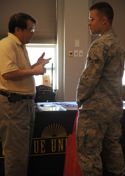 Roy Crouch, Bellevue University representative, educates Airman 1st Class Derrick Smith, 7th Logistics Readiness Squadron, on programs and classes available at the university during an education fair Oct. 18, 2011 at Dyess Air Force Base, Texas. The education center located on base sponsors multiple colleges that offer different career paths to follow. (U.S. Air Force photo by Airman 1st Class Jonathan Stefanko/ Released)