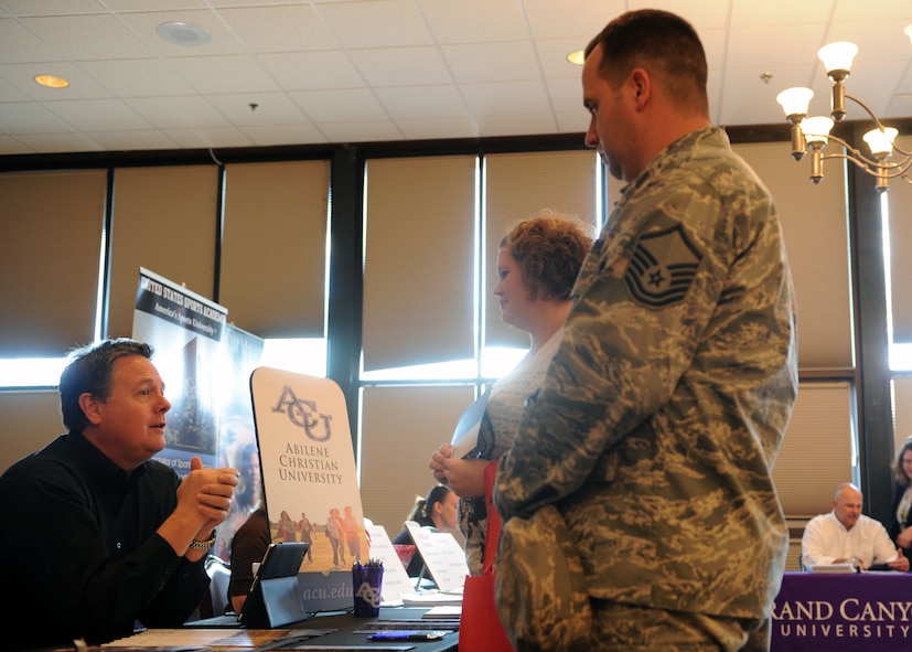 Brent Mann, Abilene Christian University representative, educates Master Sgt. Van Seigrist, 317th Maintenance Operations Squadron, and his wife Kristi on programs and classes available at the university during an education fair Oct. 18, 2011 at Dyess Air Force Base, Texas. The education center located on base sponsors multiple colleges that offer different career paths to follow. (U.S. Air Force photo by Airman 1st Class Jonathan Stefanko/ Released) 