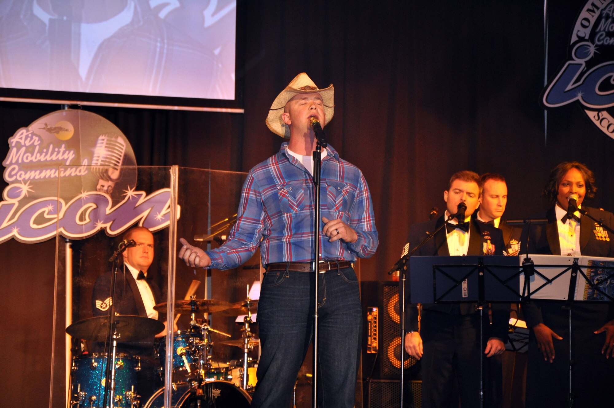 Senior Airman John Maness sings "Muddy Water" during the Air Mobility Command Icon finals competition Oct. 20, 2011, at Scott Air Force Base, Ill. Maness made it to the finals by winning the base level competition at Grand Forks AFB, N.D. Icon is an AMC commander's initiative to showcase the vocal talents of AMC Airmen. Each AMC base holds Icon contests in July and August to determine their representatives for the command final which takes place at Scott AFB. (U.S. Air Force Photo/Master Sgt. Sabrina D. Foster)