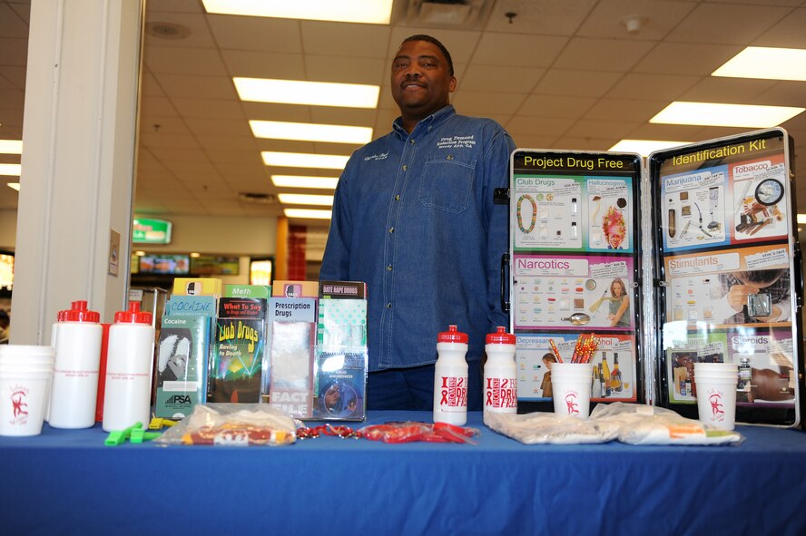 U.S. Air Force retired Chief Master Sgt. Charles Boyd Jr., Drug Demand Reduction program administrative manager at Moody Air Force Base Ga., utilizes an informational display table for the Drug Demand Reduction program at the Exchange Oct. 21, 2011. The display is set up to educate the base populace and increase awareness of drug use.  It also is used to inform Airmen on how to easily identify warning signs of drug use. (U.S. Air Force photo by Senior Airman Ciara Wymbs/Released) 

