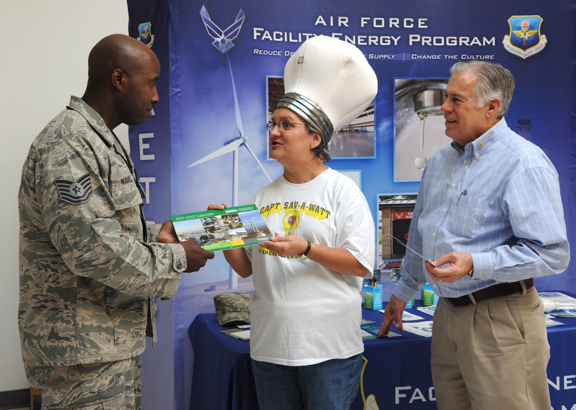 GOODFELLOW AIR FORCE BASE, Texas—Mary Lumsdon, base energy manager, and Randy Wood, recourse efficiency manager speak, to Tech. Sgt.  Lebyron Russell, a Communication Signals Intelligence Analysis Instructor, about energy conservation at the Base Exchange Oct. 20.  October is Energy Awareness Month. (U.S. Air Force photo/2nd Lt. Leanne Caballer)