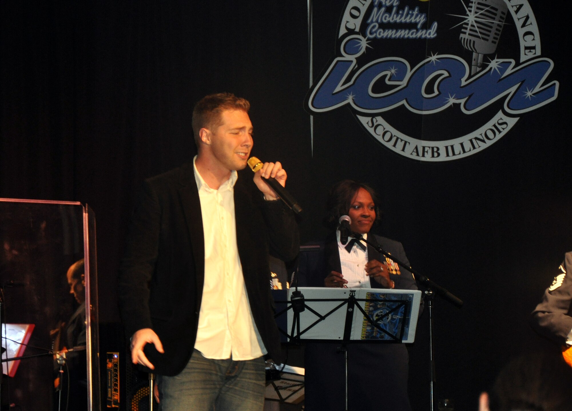 Airman 1st Class Tim Sentz sings "Why Don't We Just Dance" during the Air Mobility Command Icon finals competition Oct. 20, 2011, at Scott Air Force Base, Ill. Sentz made it to the finals by winning the base level competition at Scott AFB. Icon is an AMC commander's initiative to showcase the vocal talents of AMC Airmen. Each AMC base holds Icon contests in July and August to determine their representatives for the command final which takes place at Scott AFB. (U.S. Air Force Photo/Master Sgt. Sabrina D. Foster)