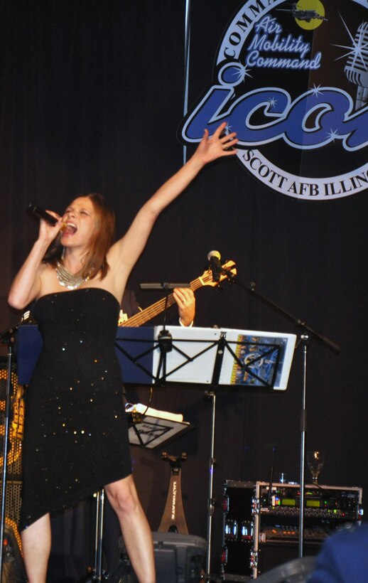 Capt. Manuela Peters sings "Defying Gravity" during the Air Mobility Command Icon finals competition Oct. 20, 2011, at Scott Air Force Base, Ill. Peters made it to the finals by winning the base level competition at Fairchild AFB and she earned second place in the finals. Icon is an AMC commander's initiative to showcase the vocal talents of AMC Airmen. Each AMC base holds Icon contests in July and August to determine their representatives for the command final which takes place at Scott AFB. (U.S. Air Force Photo/Master Sgt. Sabrina D. Foster)