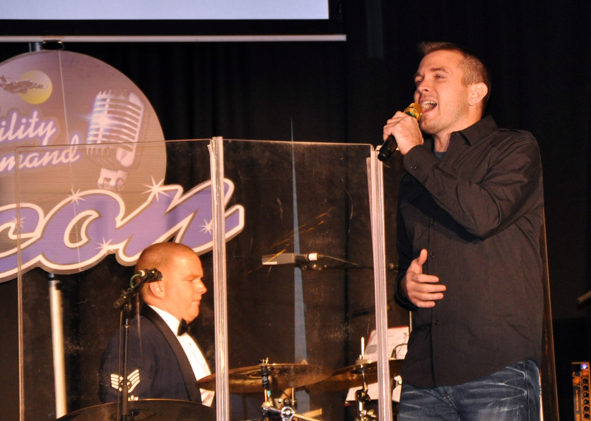 Staff Sgt. Clint Yager sings "Just The Way You Are" during the Air Mobility Command Icon finals competition Oct. 20, 2011, at Scott Air Force Base, Ill. Yager, from the 19th Component Maintenance Squadron at Little Rock Air Force Base, Fla., made it to the finals by winning the base level competition at Little Rock AFB. Icon is an AMC commander's initiative to showcase the vocal talents of AMC Airmen. Each AMC base holds Icon contests in July and August to determine their representatives for the command final which takes place at Scott AFB. (U.S. Air Force Photo/Master Sgt. Sabrina D. Foster)