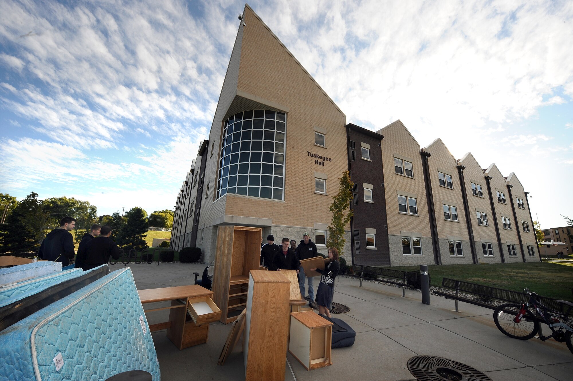 Old desks and mattresses are place in front of Tuskegee Hall during a dorm clean-up day at Offutt Air Force Base, Neb., Sept. 24.  Dumpsters were filled to the brim as old or broken furniture was taken out of dorm rooms and storage areas by Offutt Airmen to make room for new furniture.  (U.S. Air Force photo by Josh Plueger/Released)