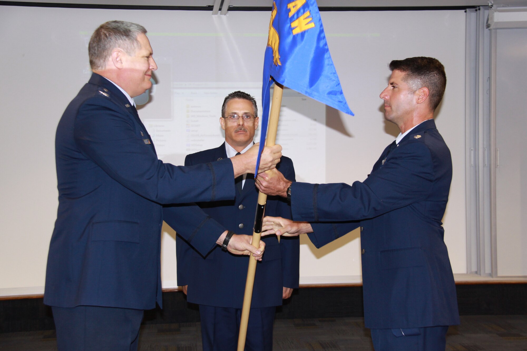 Col. Daryl Hartman, 911th Operations Group commander (left) passes the guidon to Lt. Col. Chuck Sargent (right), who assumed command of the 911th Operations Support Squadron during a ceremony held at the 911th Airlift Wing on Oct. 1, 2011.  The 911th Operations Support Squadron's primary responsibility is to provide support functions to the flying squadron by utilizing current operations, tactics, aircrew and Life Support assets. (U.S. Air Force Photo/By Captain Shawn M. Walleck)