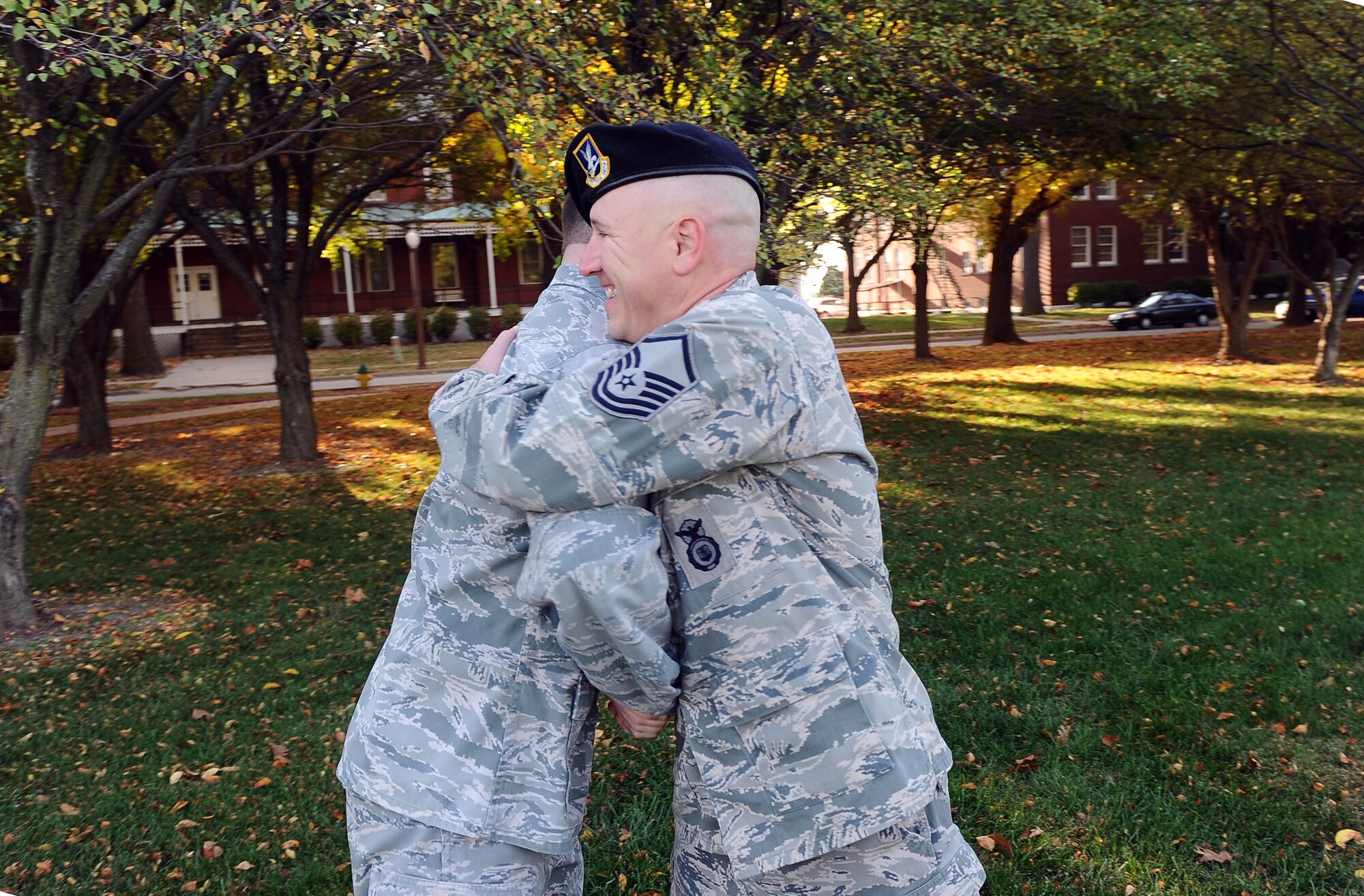 Master Sgt. David Hall, 55th Security Forces Squadron Information Fusion Cell/Investigations NCO in charge, and 1st Lt. David Nugent, U.S. Strategic Command Elite Guard officer in charge, embrace after Nugent administered of enlistment to Hall at the Offutt Air Force Base, Neb. parade grounds Oct. 6. The two work together at Offutt after being in the same cadet squadron at the U.S. Air Force Academy. (U.S  Air Force photo by Josh Plueger)