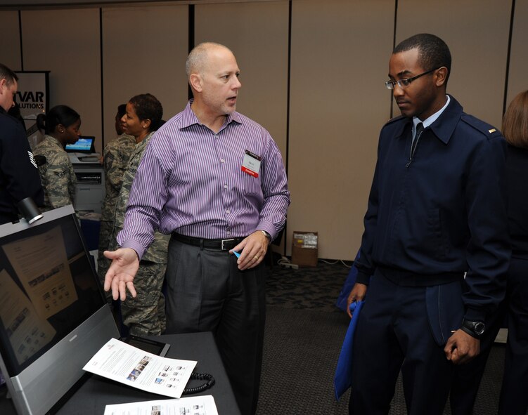 2nd Lt. Freddie L. Johnson Jr., 744th Communication Squadron deputy flight commander, receives information on One Vision Solutions Regional Sales Manager from Mr. Brian Dees Oct. 20, during the 744th Communications Squadron Technology Expo at The Club on Joint Base Andrews, Md. This year’s Tech Expo highlights civilian equipment that can be used in military applications. (U.S. Air Force photo by Staff Sgt. Christopher Ruano)