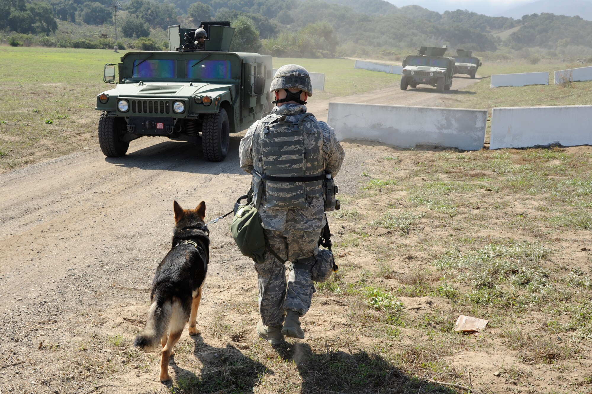 VANDENBERG AIR FORCE BASE, Calif. -- Staff Sgt. Robert Ford, a 30th Security Forces Squadron dog handler, walks to meet a convoy approaching the gate during a North Star exercise here Thursday, Oct. 20, 2011. The exercise trained Airmen during a simulated deployed environment in which they practiced deployment training and response time.   (U.S. Air Force photo/Senior Airman Lael Huss)