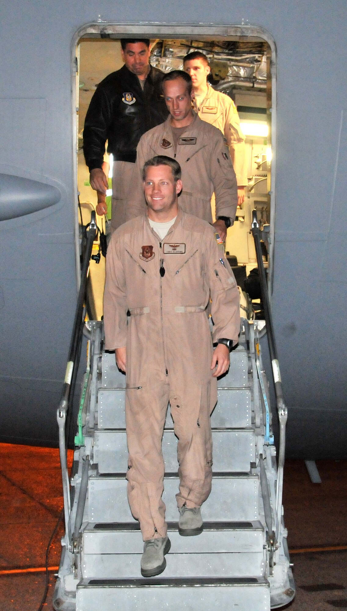 U.S. Air Force Maj. Chris Klopping (on steps), 97th Airlift Squadron instructor pilot out of McChord Field, Wash., gives his "mission accomplished" smile after he, and his fellow Reserve aircrew members, came back from transporting U.S. Secretary of State
Hillary Rodham Clinton to Tripoli, Libya, where she visited to pledge millions of dollars in new aid earlier this week. The C-17 Globemaster III crew arrived here at McChord Field, Oct. 20, 2011. An active-duty crewmember from the 62nd Airlift Wing and a Raven unit from the 627th Air Base Group also supported the mission. (U.S. Air Force photo by 2nd Lt. Lori Fiorello)
