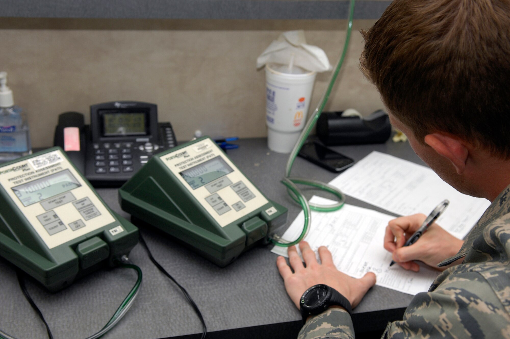 U.S. Air Force Staff Sgt. Bryan Stewart, 20th Civil Engineer Squadron readiness apprentice, signs Airmen off on the initial fit testing for the M50 gas mask, Shaw Air Force Base, S.C. Oct. 20, 2011. The M50 mask replaced the MCU-2/P gas mask to improve breathing resistance and field of view. (U.S. Air Force photo by Airman 1st Class Ashley L. Gardner/ Released)