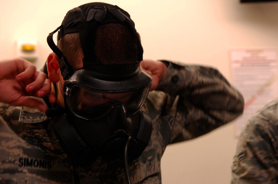 U.S. Air Force Airman 1st Class Ethan Simonis, 20th Operations Support Squadron air traffic controller apprentice, makes sure his mask fits properly for the M50 gas mask testing , Shaw Air Force Base, S.C. Oct. 20, 2011. The M50 mask replaced the MCU-2/P gas mask to improve breathing resistance and field of view. (U.S. Air Force photo by Airman 1st Class Ashley L. Gardner/ Released)