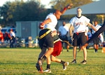 Dental wide receiver John Grey shuffles past a 559th Medical Group defender. Dental went undefeated in flag football, going 8-0 during the intramural Division I regular season. (U.S. Air Force photo/Alan Boedeker)