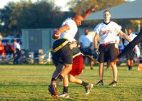 Dental wide receiver John Grey shuffles past a 559th Medical Group defender. Dental went undefeated in flag football, going 8-0 during the intramural Division I regular season. (U.S. Air Force photo/Alan Boedeker)