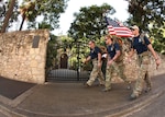 Special Tactics team members Lt. Col. Patrick Barnett, headquarters Air Force Special Operations Command, Operations Directorate, Hurlburt Field, Fla., left, Senior Airmen Stone Hazlett, 21st Special Tactics Squadron, Pope Air Force Base, N.C., center, and Senior Airman Tyler Knaub, 58th Rescue Squadron, Davis-Monthan AFB, Ariz., right, walk past the north wall of the Alamo in downtown San Antonio Sunday. (U.S. Air Force photo/Robbin Cresswell)