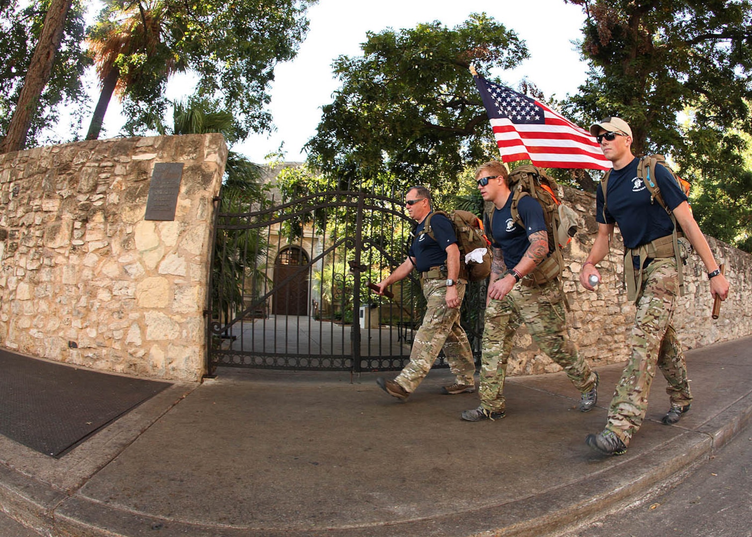 Special Tactics team members Lt. Col. Patrick Barnett, headquarters Air Force Special Operations Command, Operations Directorate, Hurlburt Field, Fla., left, Senior Airmen Stone Hazlett, 21st Special Tactics Squadron, Pope Air Force Base, N.C., center, and Senior Airman Tyler Knaub, 58th Rescue Squadron, Davis-Monthan AFB, Ariz., right, walk past the north wall of the Alamo in downtown San Antonio Sunday. (U.S. Air Force photo/Robbin Cresswell)