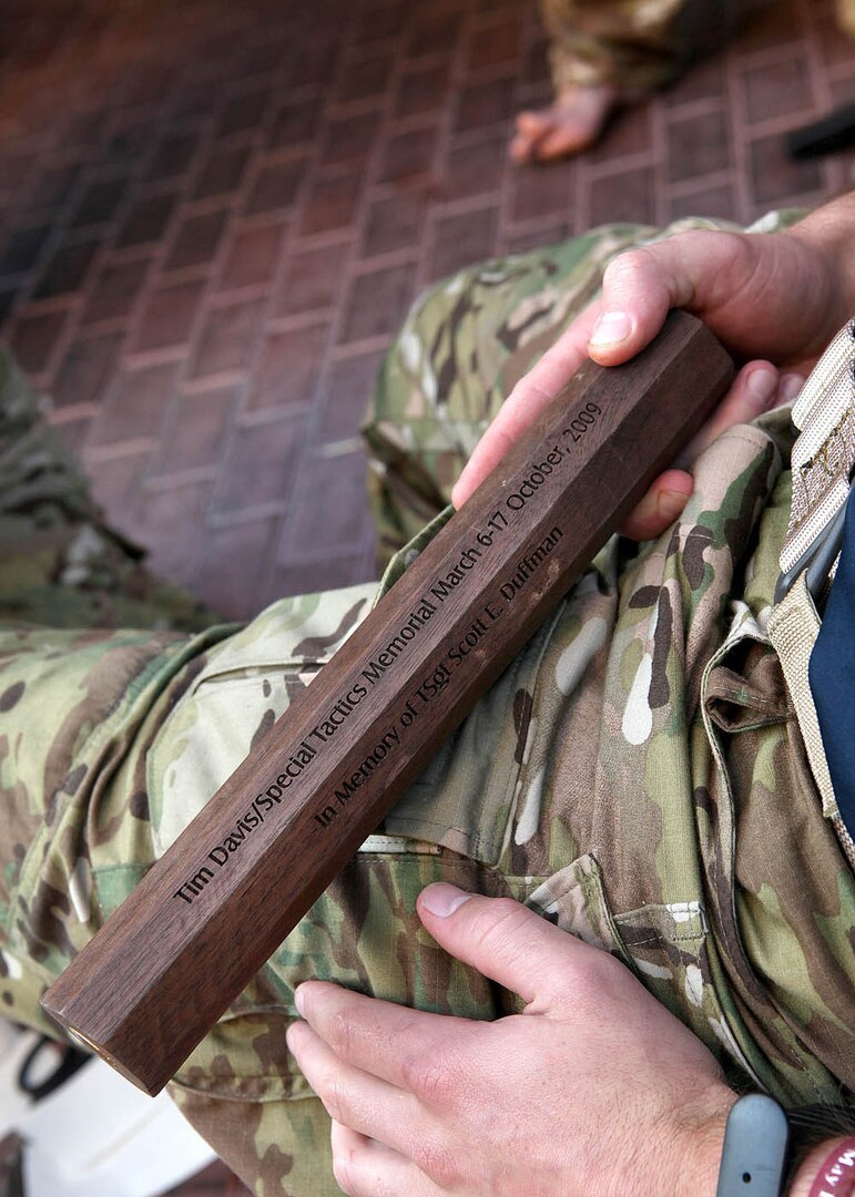 Senior Airman Stone Hazlett, a combat controller stationed at Pope Air Force Base, N.C., holds the original baton bearing the name of Staff Sgt. Tim Davis, a combat controller killed by an improvised explosive device Feb. 20, 2009 during Operation Enduring Freedom. (U.S. Air Force photo/Robbin Cresswell)