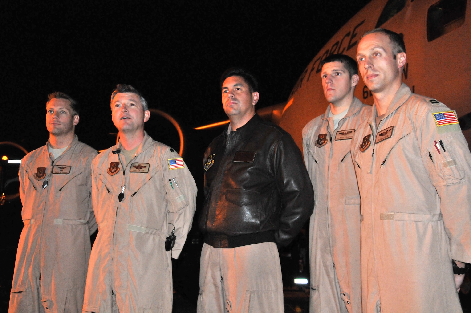 Air Force Reservists from the 97th Airlift Squadron, McChord Field, Wash., (from left to right) Maj. Chris Klopping, Lt. Col. Scott Ryan, Master Sgt. Jeremy Parker, Airman 1st Class Bradley Stratton, and Capt. Richard Matthews, stand in front of the C-17 Globemaster III that transported precious cargo in the form of U.S. Secretary of State Hillary Rodham Clinton to Tripoli, Libya earlier this week. The crew finally landed here at McChord Field, Oct. 20, 2011. An active-duty crewmember from the 62nd Airlift Wing and a Raven unit from the 627th Air Base Group also supported the mission. (U.S. Air Force photo by 2nd Lt. Lori Fiorello)
