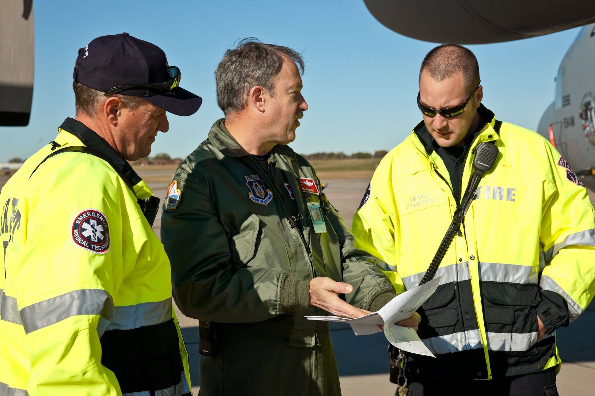 Lt. Col. Tim Purcell, 934th Airlift Wing safety officer, trains members of the Metropolitan Airport Commission firefighters on C-130 emergency egress procedures. (Air Force Photo/Shannon McKay)