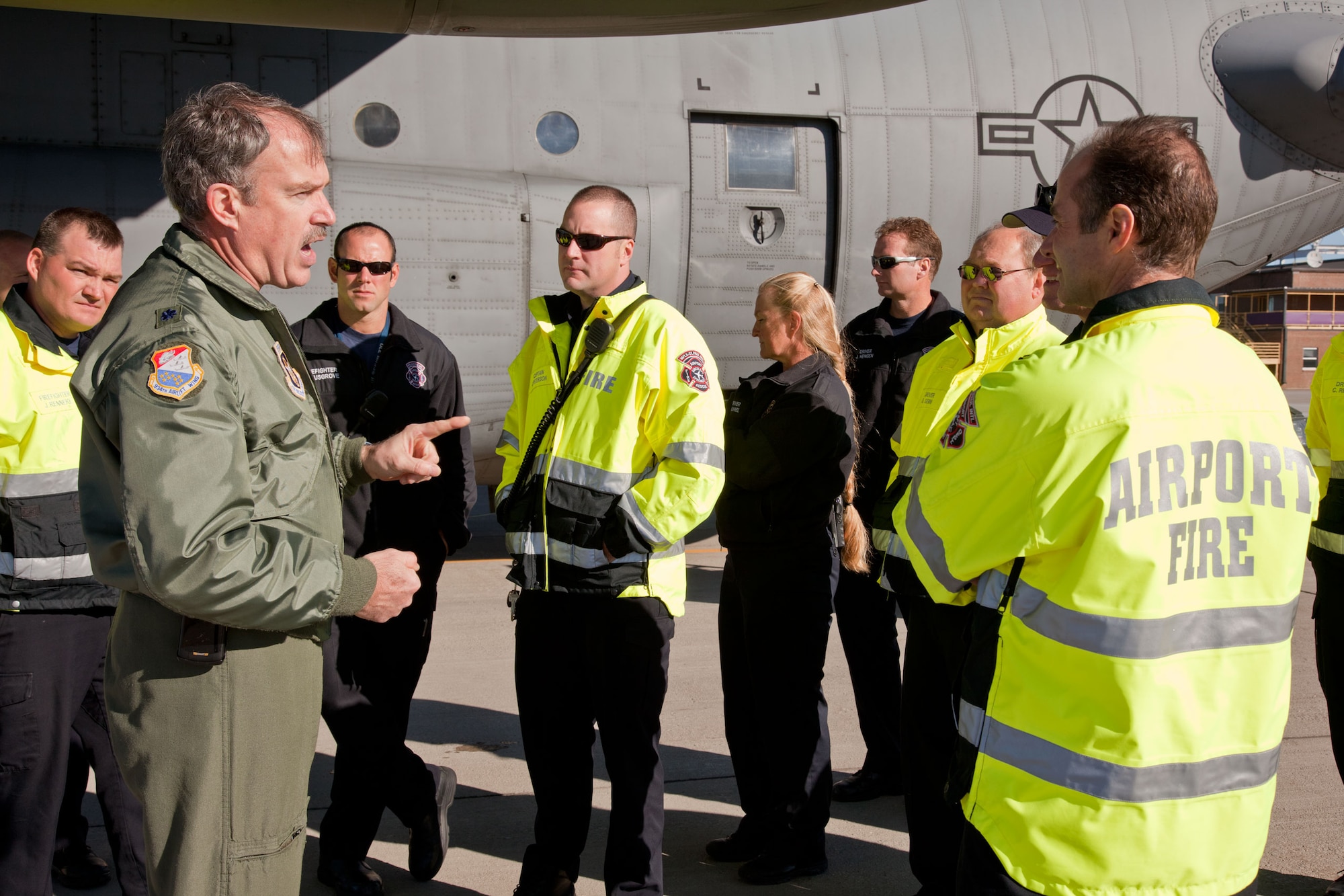Lt. Col. Tim Purcell, 934th Airlift Wing safety officer, trains members of the Metropolitan Airport Commission firefighters on C-130 emergency egress procedures. (Air Force Photo/Shannon McKay)