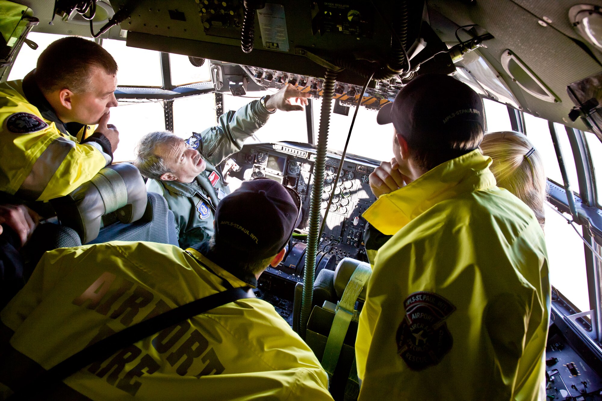 Lt. Col. Tim Purcell, 934th Airlift Wing safety officer, trains members of the Metropolitan Airport Commission firefighters on C-130 emergency egress procedures. (Air Force Photo/Shannon McKay)
