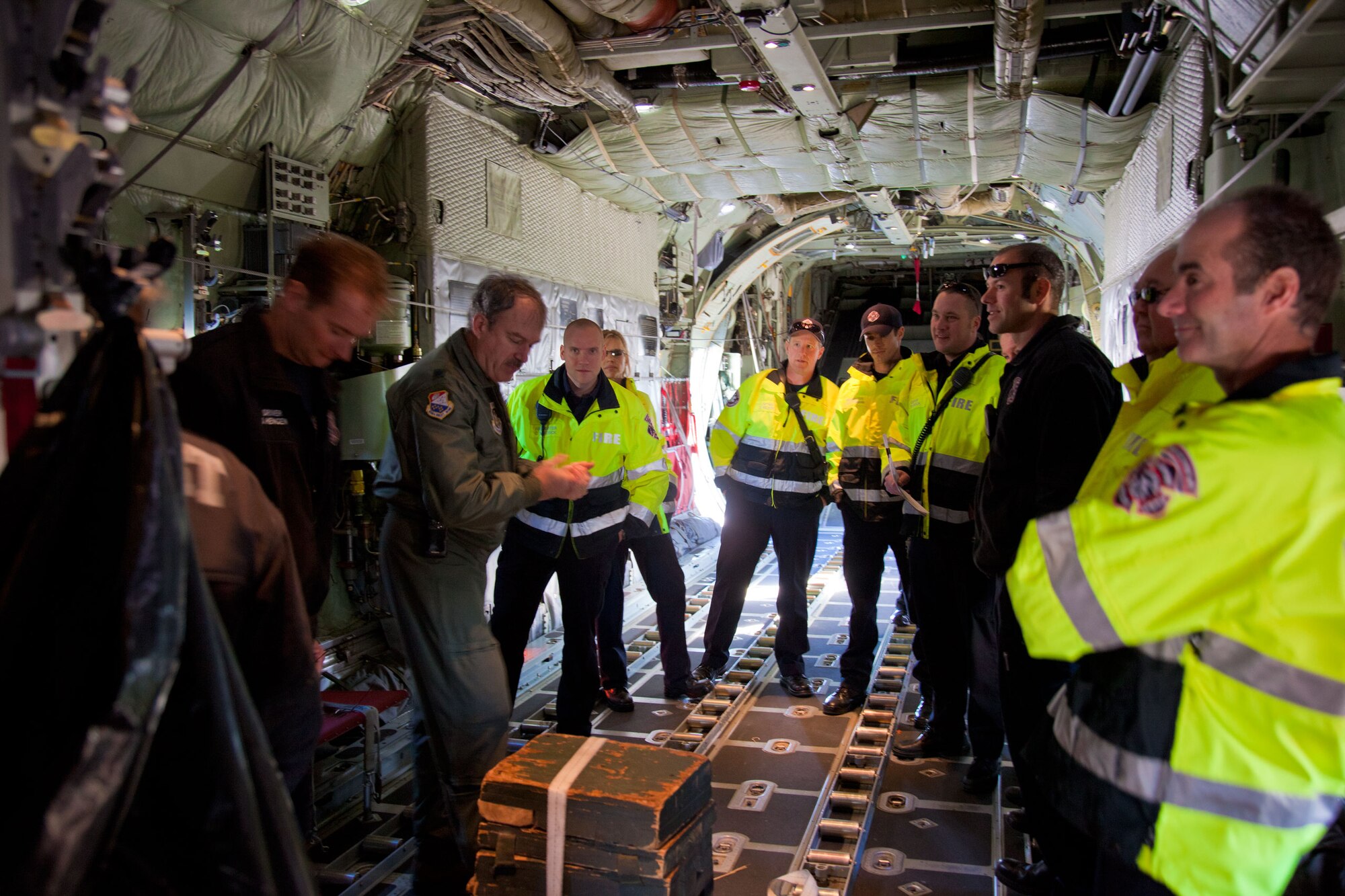 Lt. Col. Tim Purcell, 934th Airlift Wing safety officer, trains members of the Metropolitan Airport Commission firefighters on C-130 emergency egress procedures. (Air Force Photo/Shannon McKay)