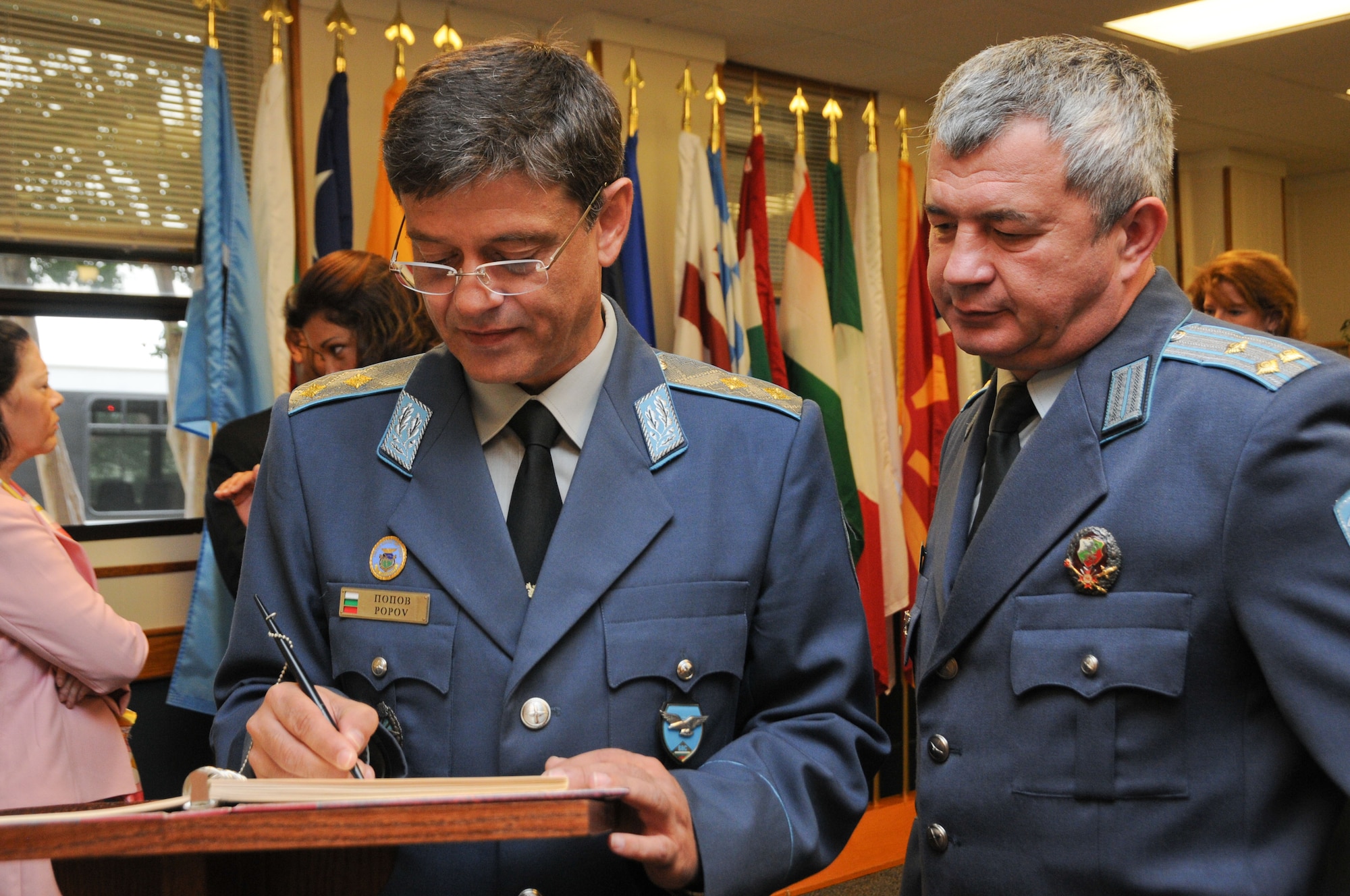 Left, Maj. Gen. Constantin Veselinov Popov, commander of the Bulgarian Air Force and Air War College graduate from 2000, signs a memory book as part of the Honor Roll at the International Officer School Wednesday. Popov was among the 19 selectees inducted this year. The award highlights partnerships between the U.S. and other nations, as well as the accomplishments of the honorees, who have attained the military or civilian rank of chief of staff or higher. (Air Force photo/Chris Baldwin)
