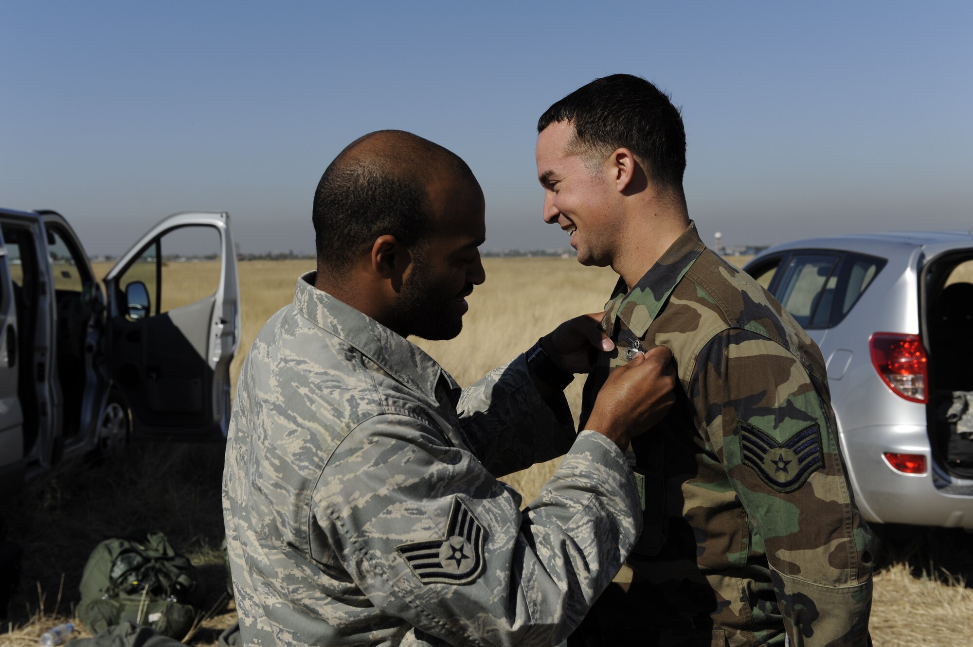 Staff Sgt. Myron Austin, 435th Contingency Response Group jumpmaster, presents Staff Sgt. Nick Hurst, 435th CRG paratrooper, his Master Parachutist badge during Operation Thracian Fall 2011, Oct. 20, 2011, Plovdiv, Bulgaria. Hurst earned his master rating after completing his 65th static line jump. OTF11 is off-station training designed to enhance interoperability between U.S. and Bulgarian Air Forces as well as build partnerships with paratroopers from both. (U.S. Air Force photo by Senior Airman Stephen J. Otero)