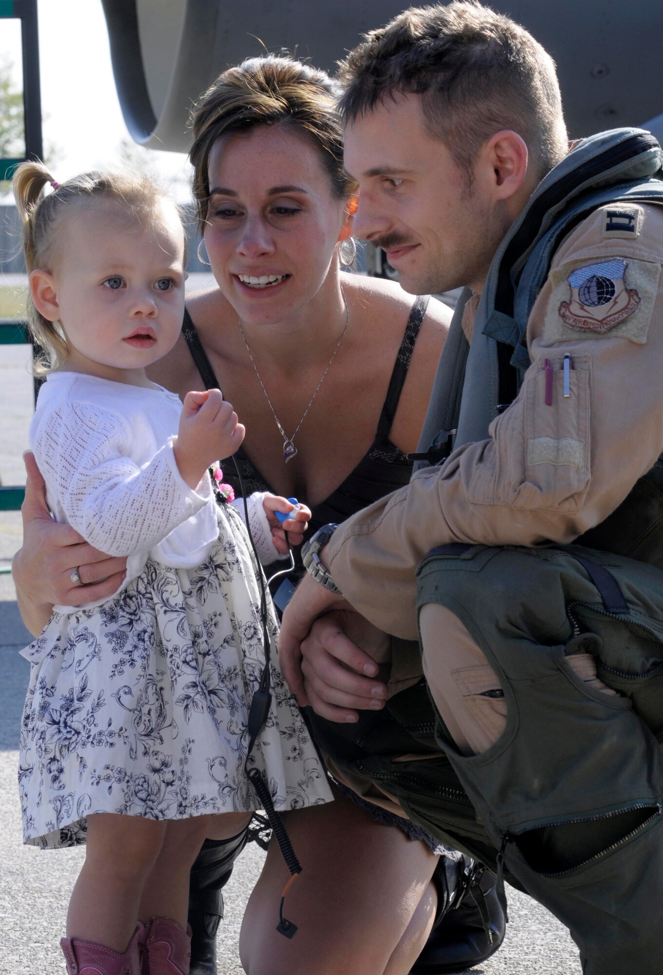 Capt. Steve Wilhoit, 555th Fighter Squadron F-16 pilot and assistant training officer, greets his 2-year-old daughter, Hannah, and his wife, Julia, Oct.18 at Aviano Air Base, Italy. Wilhoit and other Airmen and civilians with the 555th Aviation Package returned home to an anxious crowd of families, friends and coworkers after returning from their six-month deployment to Afghanistan. (U.S. Air Force photo/Airman 1st Class Briana Jones)