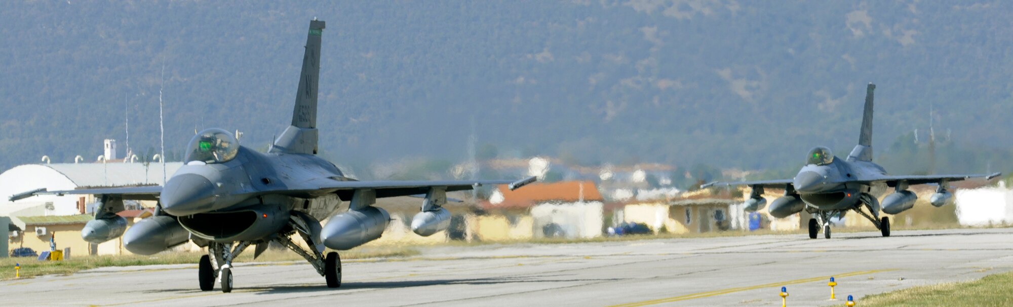 F-16 Fighting Falcons with the 555th Fighter Squadron taxi on the flight line Oct.18 at Aviano Air Base, Italy. Airmen and civilians with the 555th Aviation Package received a warm welcome from families, friends and coworkers after returning from their six-month deployment to Afghanistan. (U.S. Air Force photo/Airman 1st Class Briana Jones)