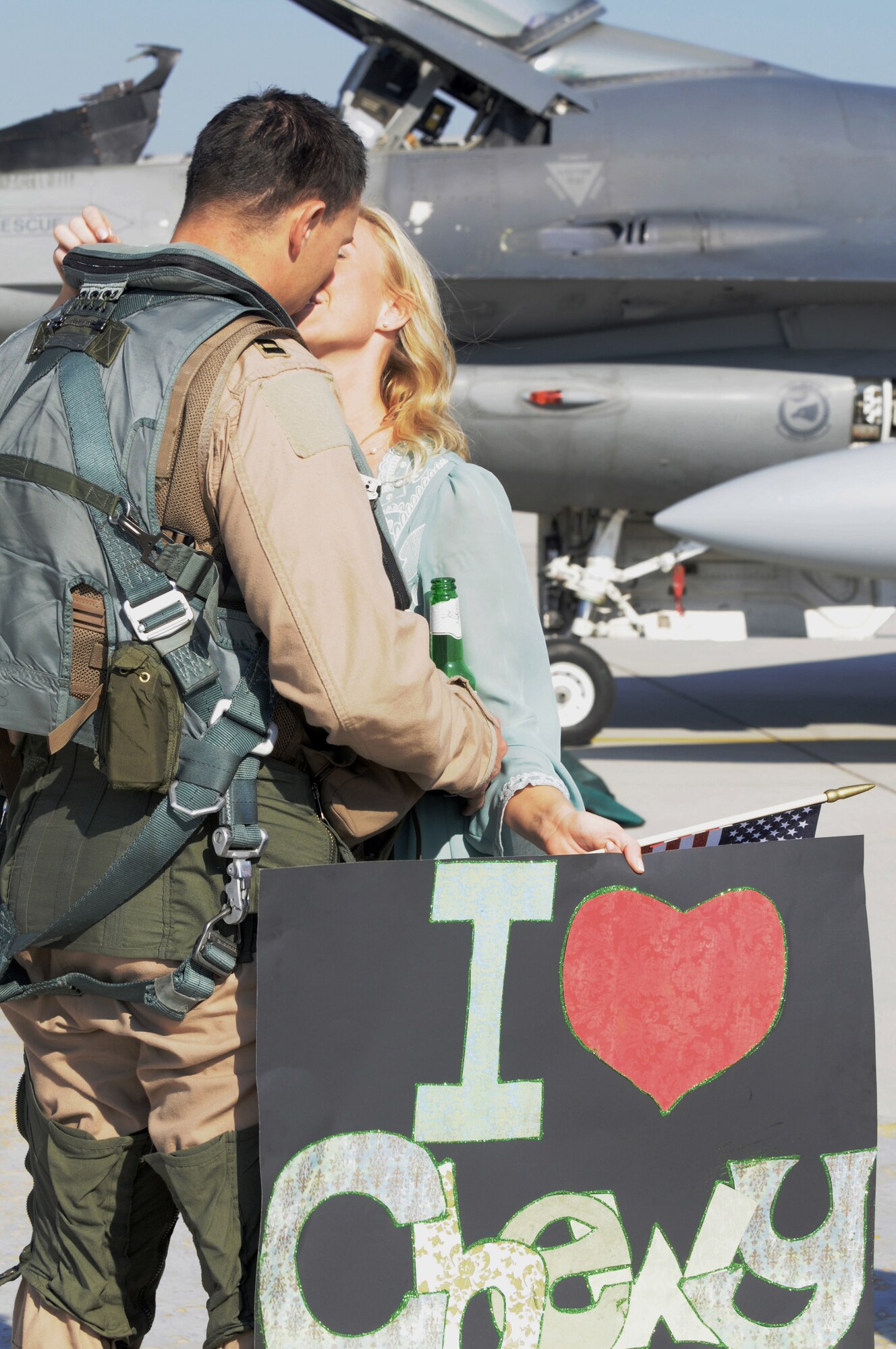 Capt. Brian Lewis, 555th Fighter Squadron F-16 pilot and chief of scheduling, kisses his wife, Kelia, Oct. 18 on the flight line at Aviano Air Base, Italy. Airmen and civilians with the 555th Aviation Package received a warm welcome from families, friends and coworkers after returning from their six-month deployment to Afghanistan. (U.S. Air Force photo/Airman 1st Class Jenay Randolph)
