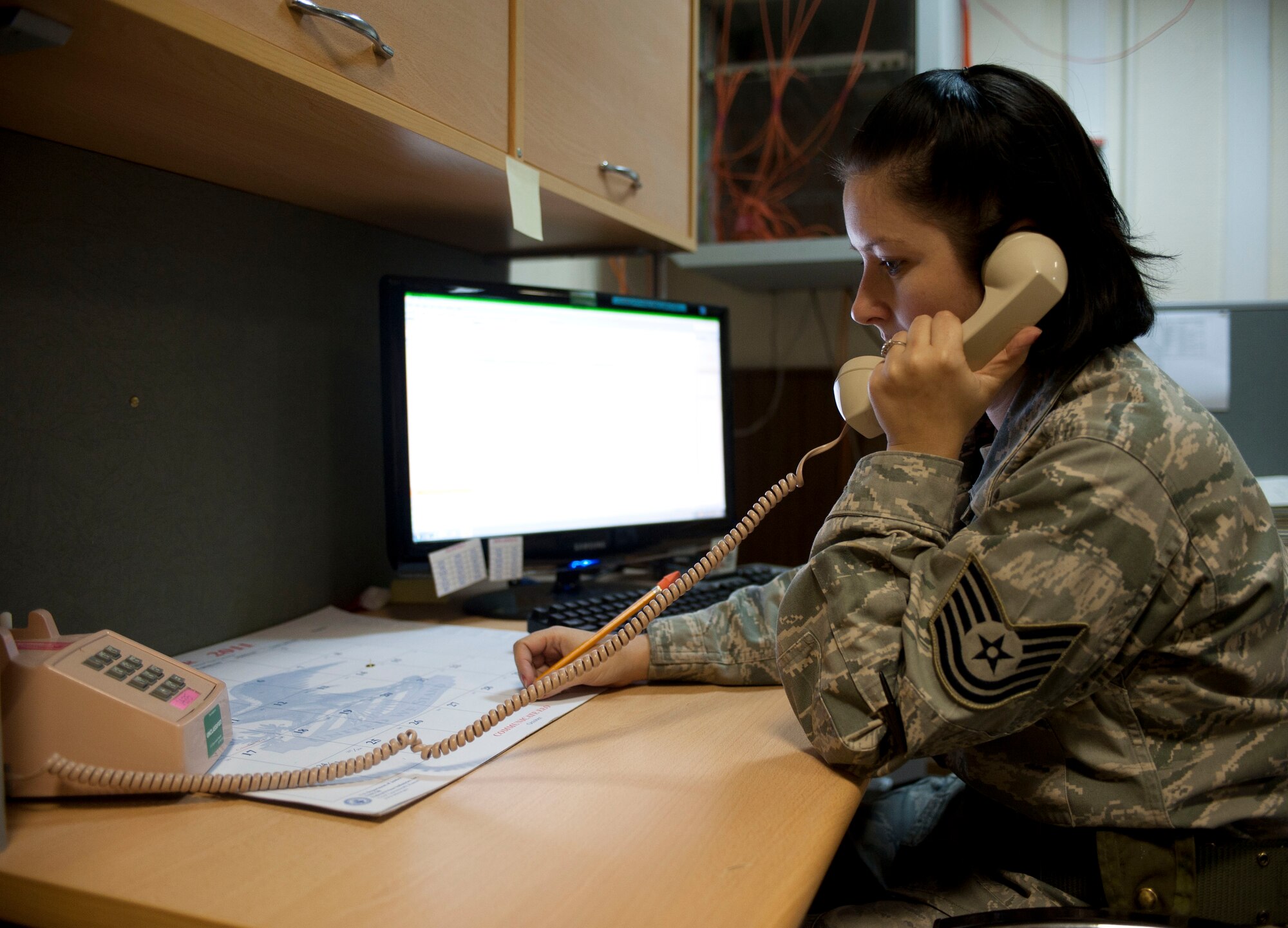 Tech. Sgt. Donna Barnhill, 39th Air Base Wing command post, uses the phone Oct. 20, 2011, at Incirlik Air Base, Turkey. The command post is responsible for relaying emergency messages across the base and to commanders, along with getting emergency responders to emergencies quickly.(U.S. Air Force photo by Senior Airman Clayton Lenhardt/Released)