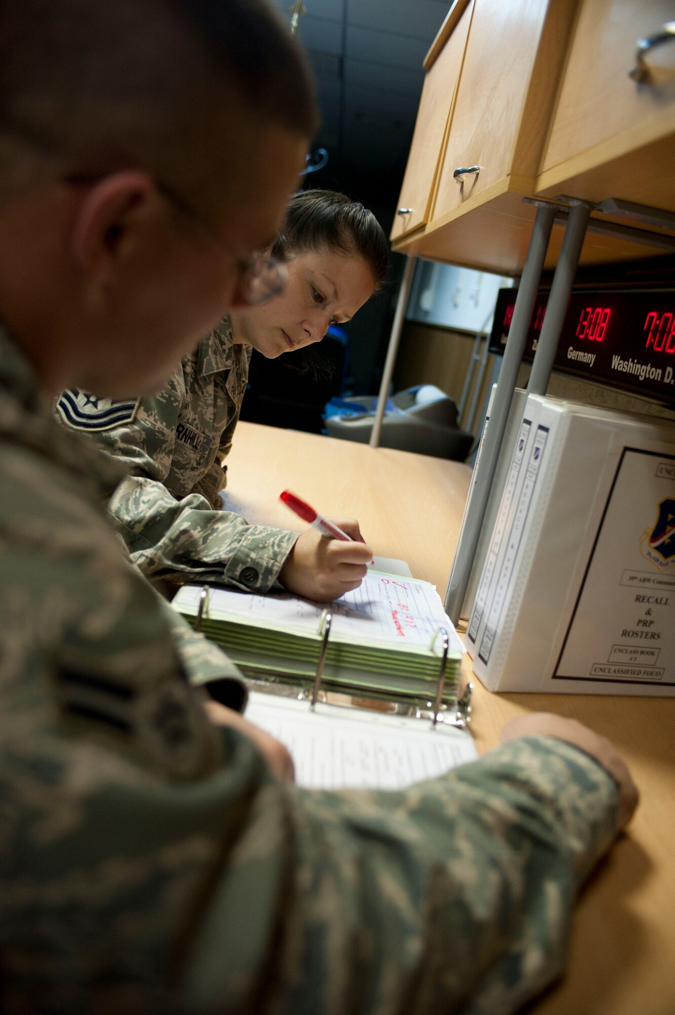 Tech. Sgt. Donna Barnhill and Airman 1st Class Nicholas Hiestand, 39th Air Base Wing command post, fill out an emergency response checklist Oct. 20, 2011, at Incirlik Air Base, Turkey. The command post is responsible for relaying emergency messages across the base and to commanders, along with getting emergency responders to emergencies quickly.(U.S. Air Force photo by Senior Airman Clayton Lenhardt/Released) 