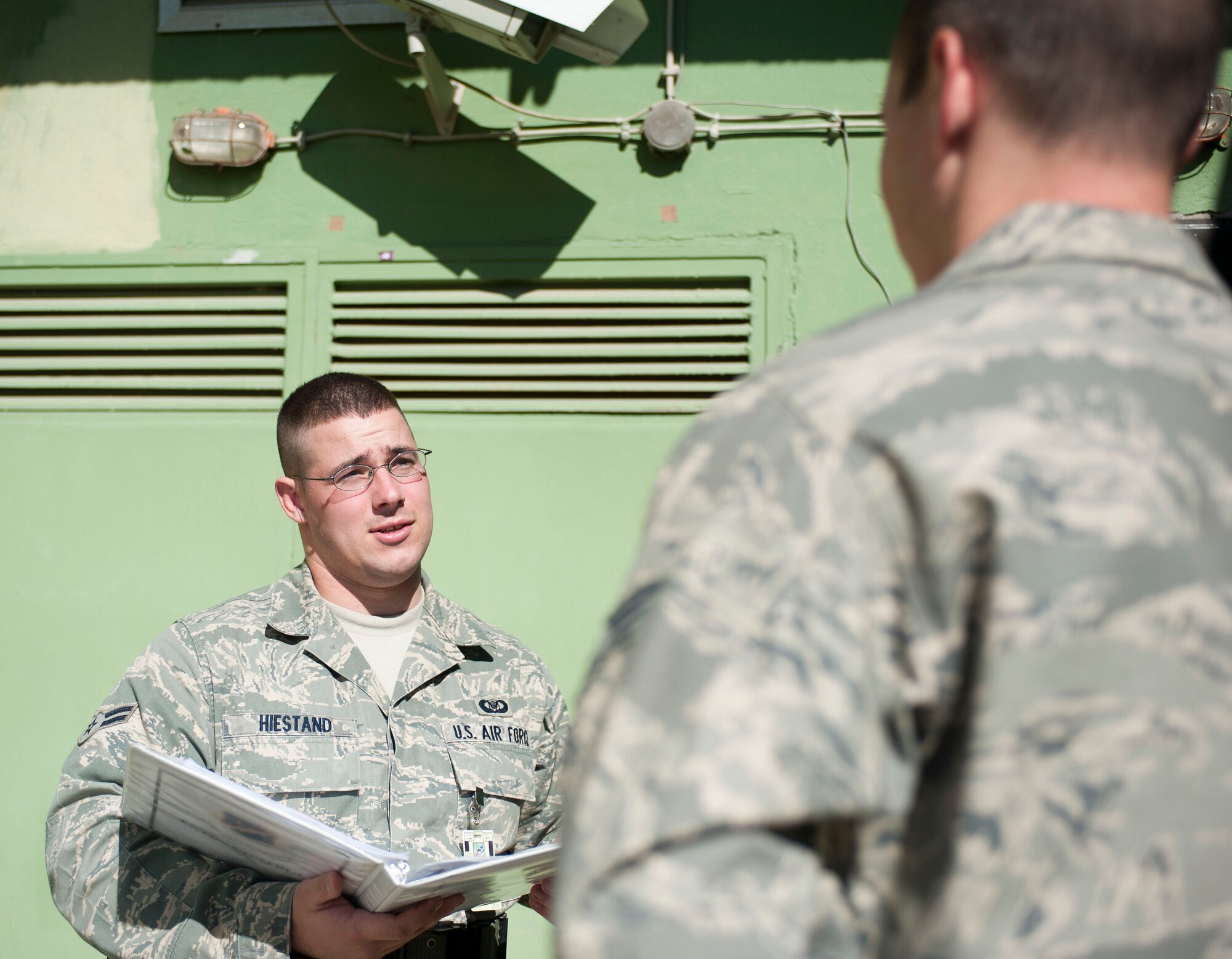 Airman 1st Class Nicholas Hiestand, 39th Air Base Wing command post, briefs a visitor before escorting him into the command post Oct. 20, 2011, at Incirlik Air Base, Turkey. The command post is responsible for relaying emergency messages across the base and to commanders, along with getting emergency responders to emergencies quickly.(U.S. Air Force photo by Senior Airman Clayton Lenhardt/Released)