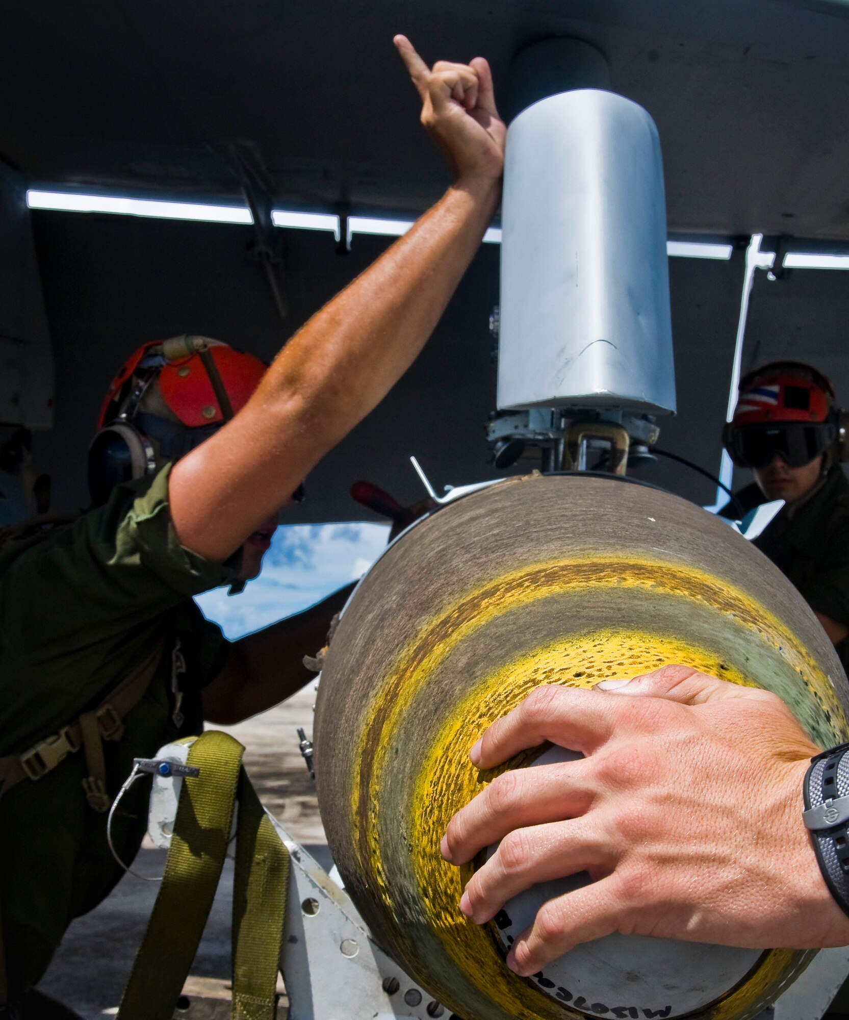 ANDERSEN AIR FORCE BASE, Guam—A joint direct attack munitions (JDAM) guided air-to-surface bomb is attached to an F/A-18 Hornet fighter jet by members of Marine Fighter Attack Squadron 115 from Marine Corps Air Station Iwakuni, Japan, during a month-long deployment to Andersen here, Oct. 20. The Marine Aviation Logistics Squadron 12, Marine Fighter Attack Squadron 115 and Strike Fighter Squadron 94 arrived on Oct. 6, to begin aerial and ground training on Andersen as part of a month-long deployment to improve combat efficiency.  (U.S. Air Force photo by Senior Airman Benjamin Wiseman/Released)