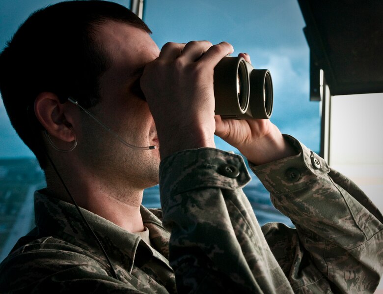 ANDERSEN AIR FORCE BASE, Guam—Airman 1st Class Mason Martinez, 36th Operations Support Squadron air traffic controller scans the flightline as F/A-18 Hornet fighter jets take off here, Oct. 20. Airmen from the 36 OSS assisted deployed U.S. Marine and U.S. Navy forces with the take-off and recovery of jets throughout their deployment to the base. (U.S. Air Force photo by Senior Airman Benjamin Wiseman/Released)